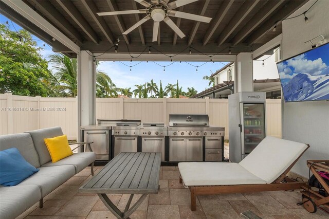 view of patio with ceiling fan and area for grilling