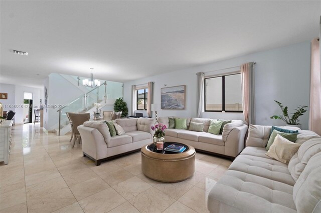 tiled living room with a chandelier