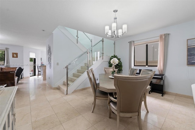 tiled dining area with an inviting chandelier