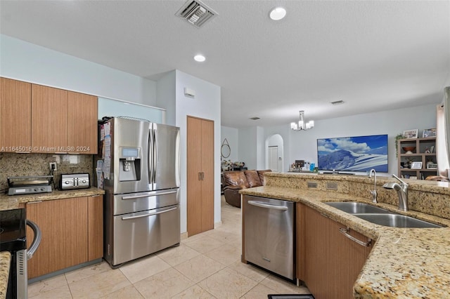 kitchen featuring decorative backsplash, light stone countertops, light tile patterned floors, sink, and stainless steel appliances