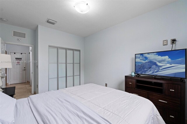 bedroom featuring a closet and light tile patterned flooring