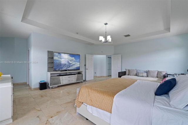 bedroom with a tray ceiling, light tile patterned flooring, and a chandelier