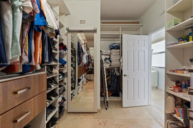 spacious closet with light tile patterned floors