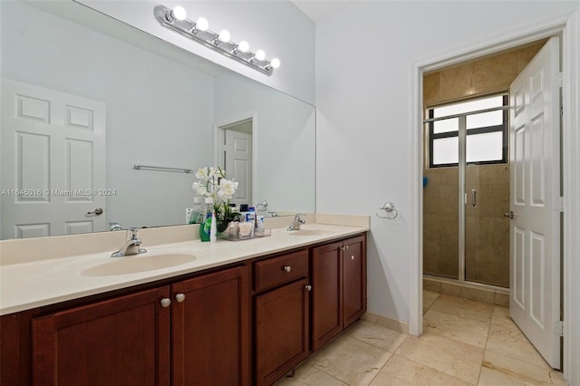 full bath with double vanity, a stall shower, a sink, and baseboards