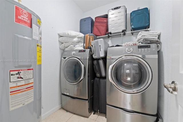 laundry room with light tile patterned floors, washer and dryer, and water heater