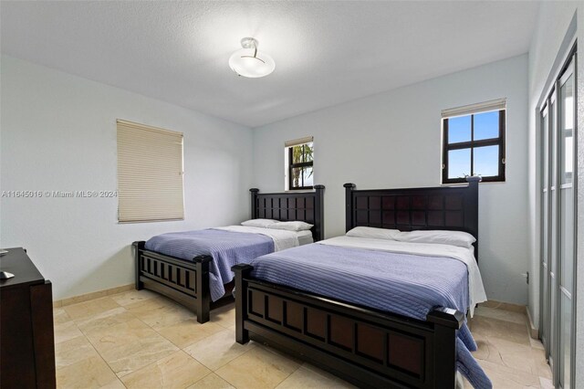 bedroom with light tile patterned floors