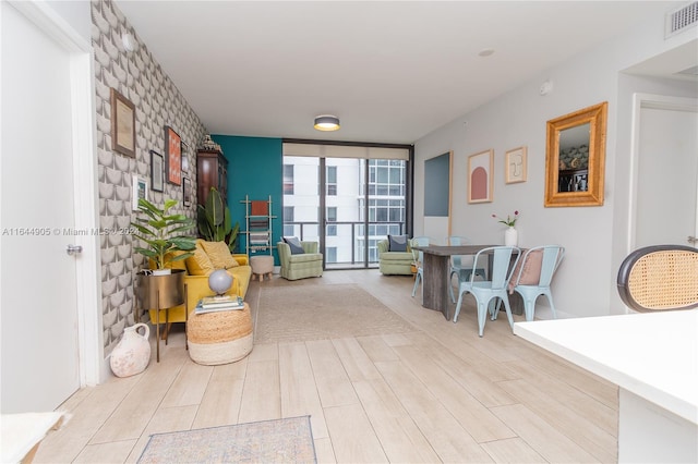 hall with light hardwood / wood-style flooring and floor to ceiling windows