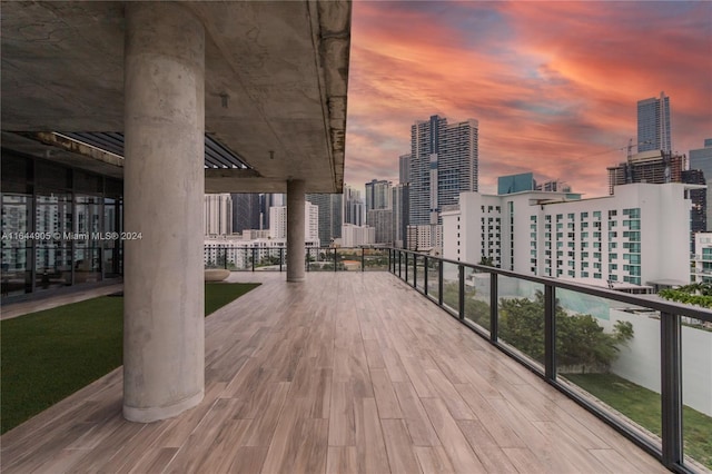 patio terrace at dusk featuring a balcony