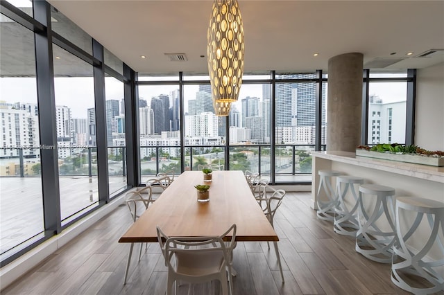 dining room with a healthy amount of sunlight and a wall of windows