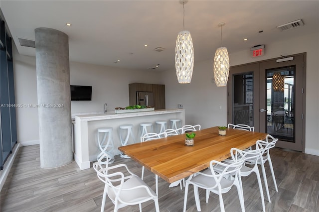 dining room with sink and wood-type flooring