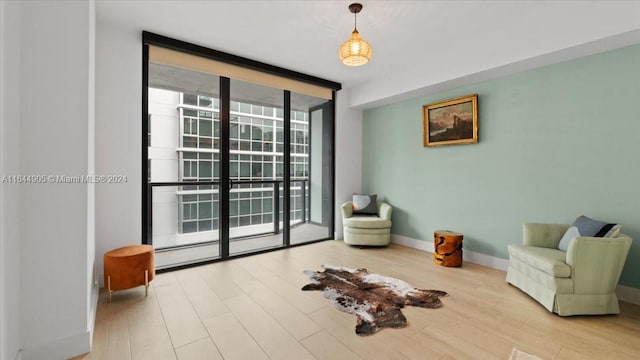 living area featuring light hardwood / wood-style flooring and floor to ceiling windows