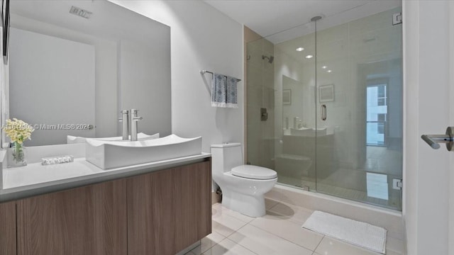 bathroom featuring toilet, an enclosed shower, vanity, and tile patterned flooring