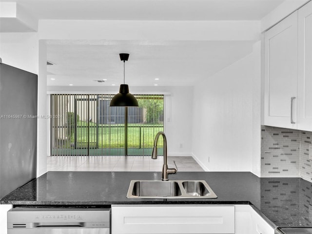 kitchen with white cabinetry, tasteful backsplash, sink, dishwashing machine, and hanging light fixtures