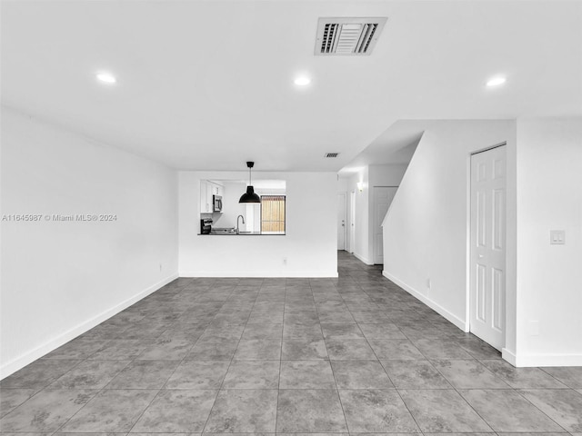 interior space featuring sink and tile patterned flooring