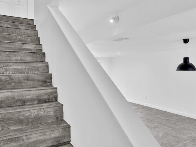 staircase featuring tile patterned floors