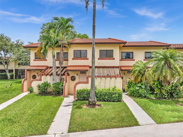 mediterranean / spanish-style house with a front lawn