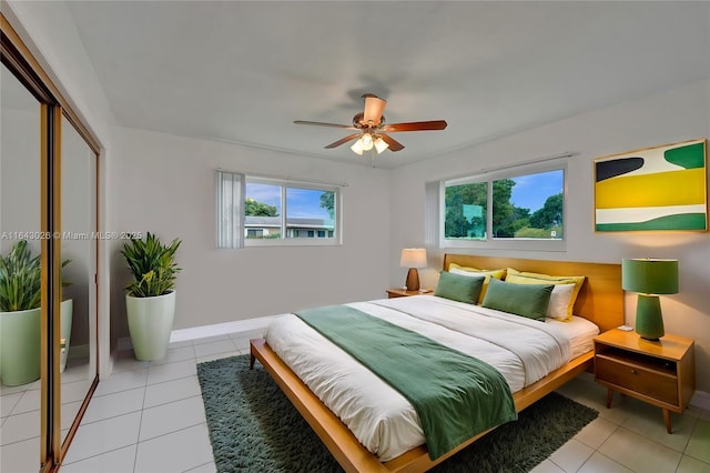 tiled bedroom with ceiling fan