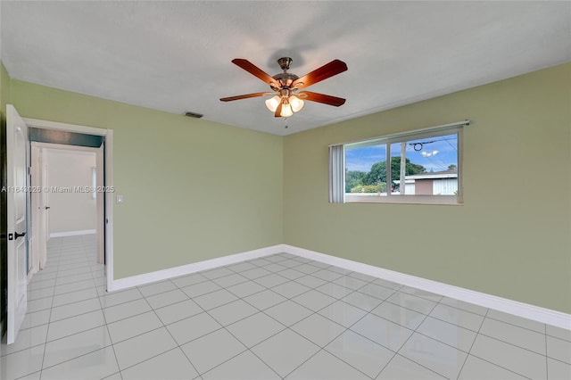 spare room featuring light tile patterned floors and ceiling fan