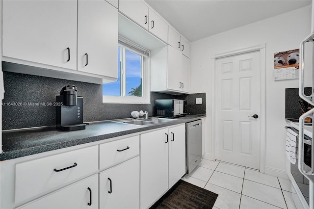 kitchen with white cabinetry, dishwasher, sink, tasteful backsplash, and light tile patterned floors