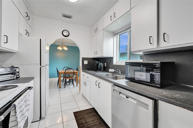 kitchen featuring decorative backsplash, white cabinets, sink, dishwasher, and light tile patterned flooring