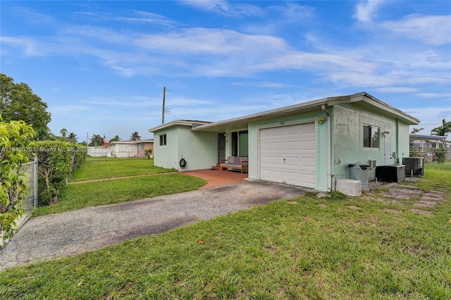 single story home featuring central air condition unit, a front yard, and a garage