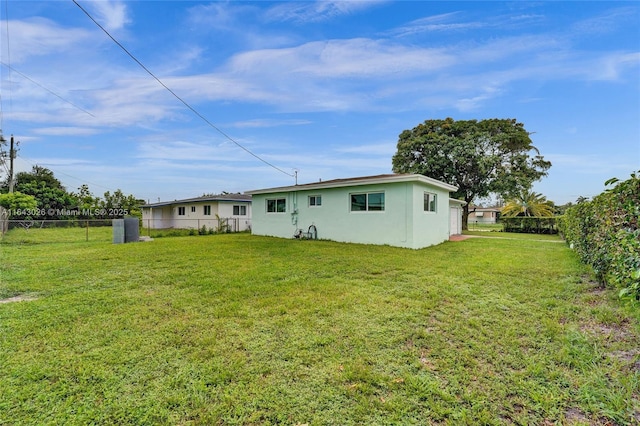 rear view of property featuring a lawn