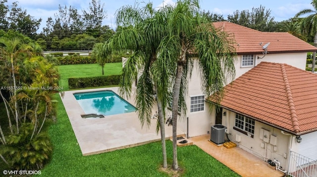 view of swimming pool with a yard, a patio area, and central AC