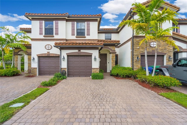 mediterranean / spanish-style home with a garage