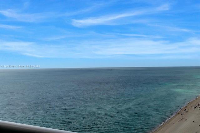 drone / aerial view featuring a water view and a beach view