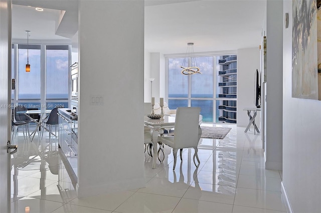 dining room with expansive windows, a chandelier, and light tile patterned floors