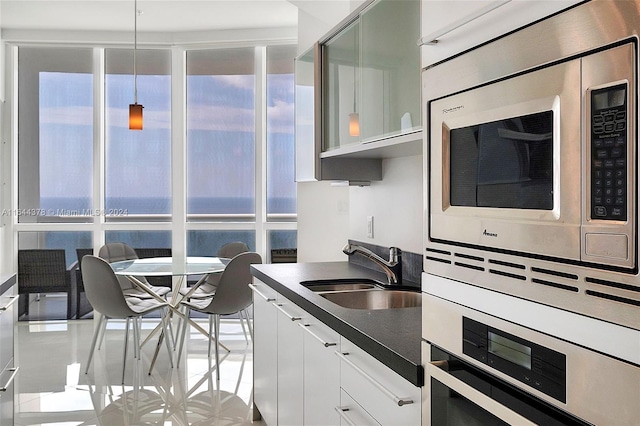 kitchen featuring white cabinetry, a healthy amount of sunlight, stainless steel appliances, and sink