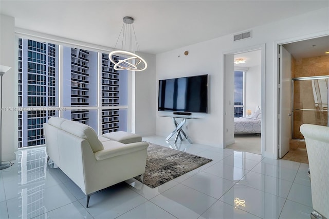 living room with a chandelier and light tile patterned floors