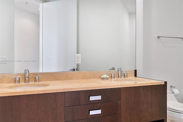 bathroom with toilet and vanity