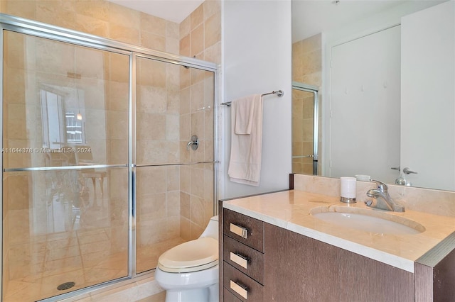 bathroom with vanity, toilet, and an enclosed shower