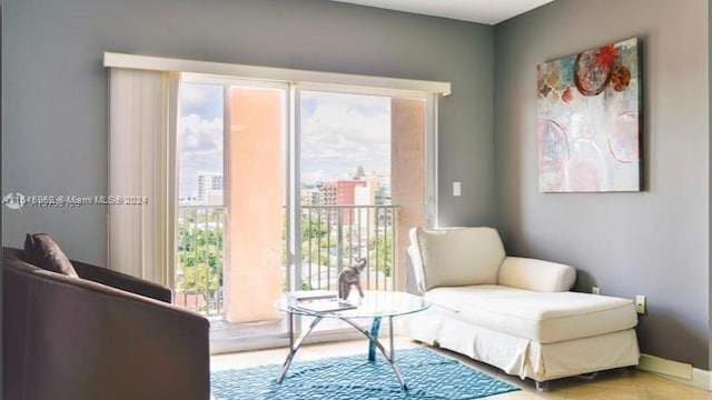 sitting room featuring baseboards and a city view