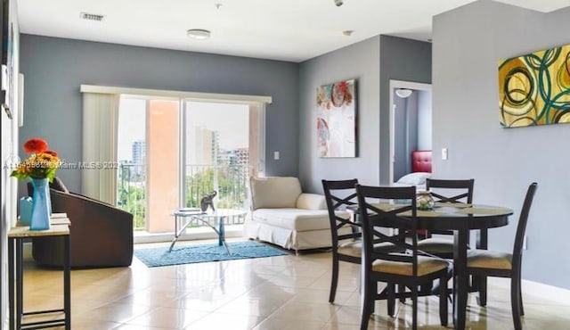 dining space with light tile patterned floors, baseboards, and visible vents