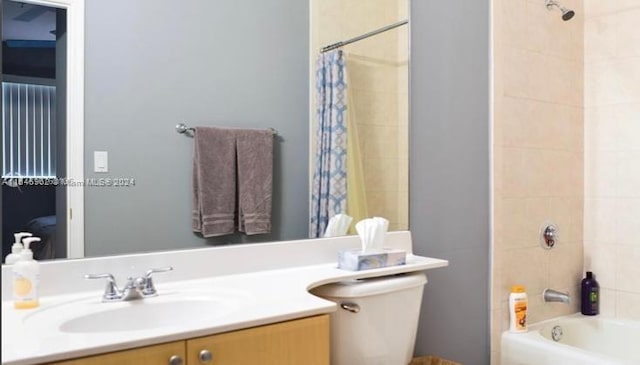 full bathroom with shower / bathtub combination with curtain, vanity, and toilet