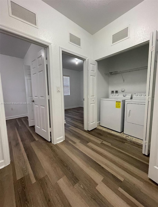 laundry room with dark hardwood / wood-style flooring and washer and dryer