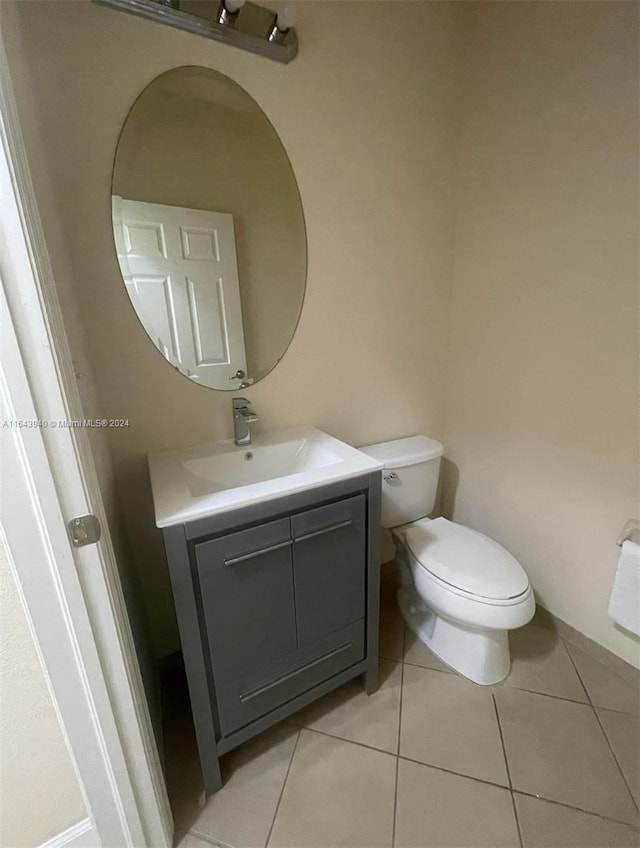 bathroom with vanity, toilet, and tile patterned floors