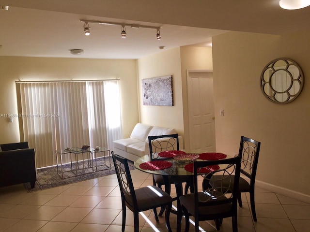 dining space with light tile patterned floors and baseboards