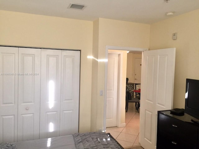 bedroom featuring a closet, visible vents, and light tile patterned floors