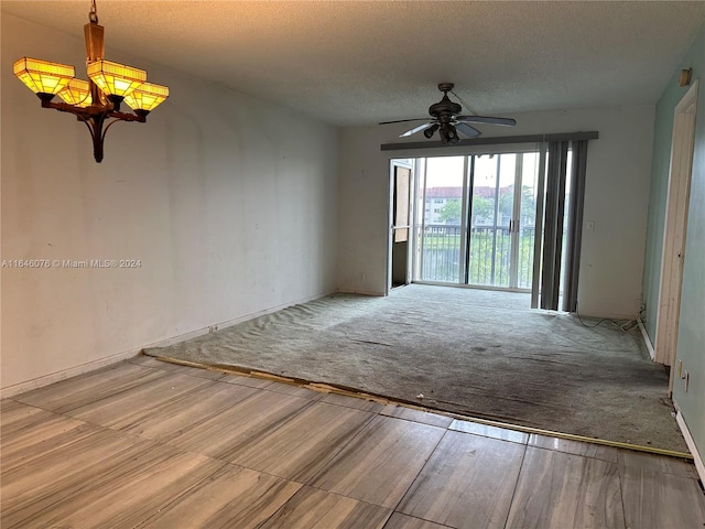 spare room with ceiling fan, light carpet, and a textured ceiling