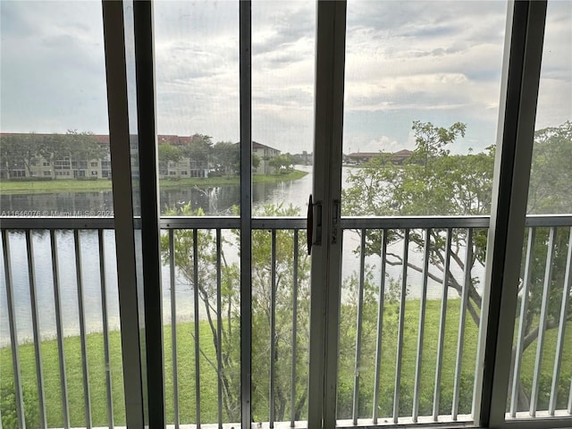 unfurnished sunroom with a water view