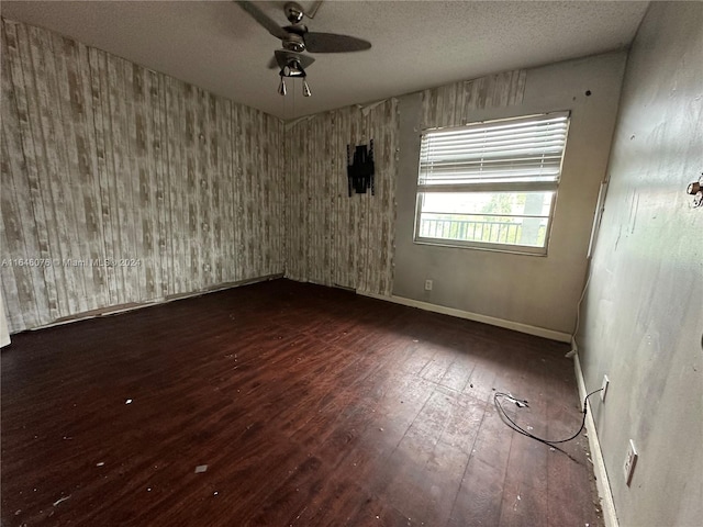 unfurnished room with hardwood / wood-style floors, ceiling fan, and a textured ceiling