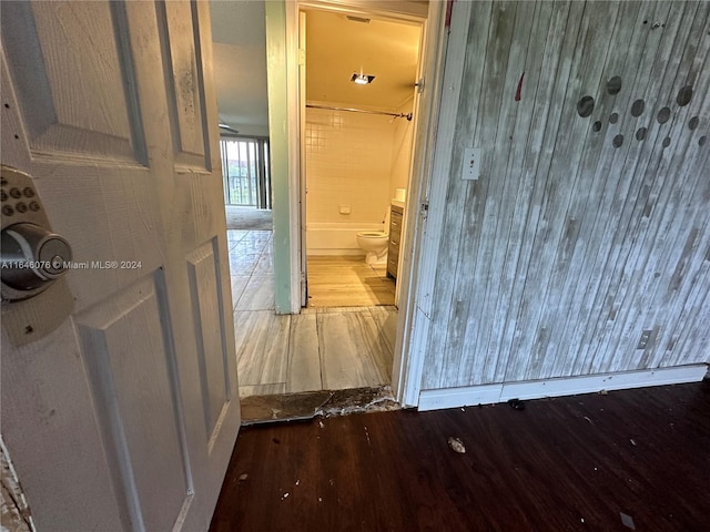 hallway with hardwood / wood-style floors