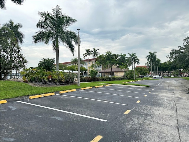 view of parking / parking lot with a yard