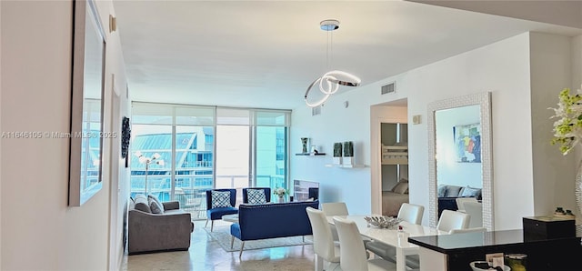 dining room with visible vents and a wall of windows