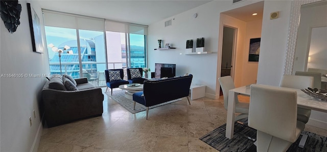 3131 NE 188th St Unit 1-810, Aventura, FL 33180 - living room with a wall of windows, visible vents, and baseboards