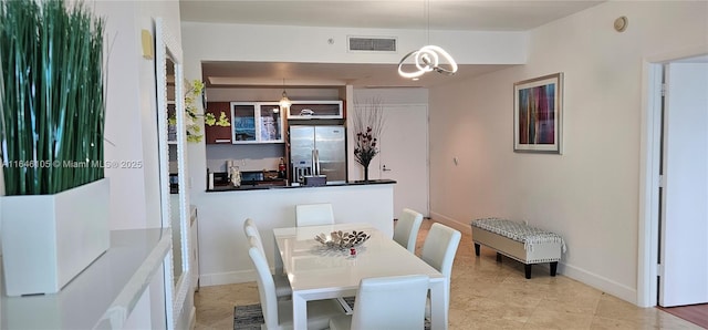 dining area with a chandelier, visible vents, and baseboards