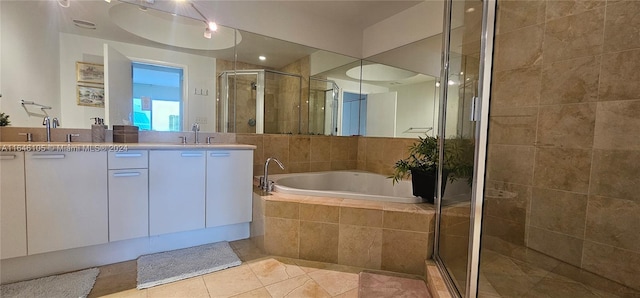 bathroom featuring tile patterned flooring, vanity, and shower with separate bathtub